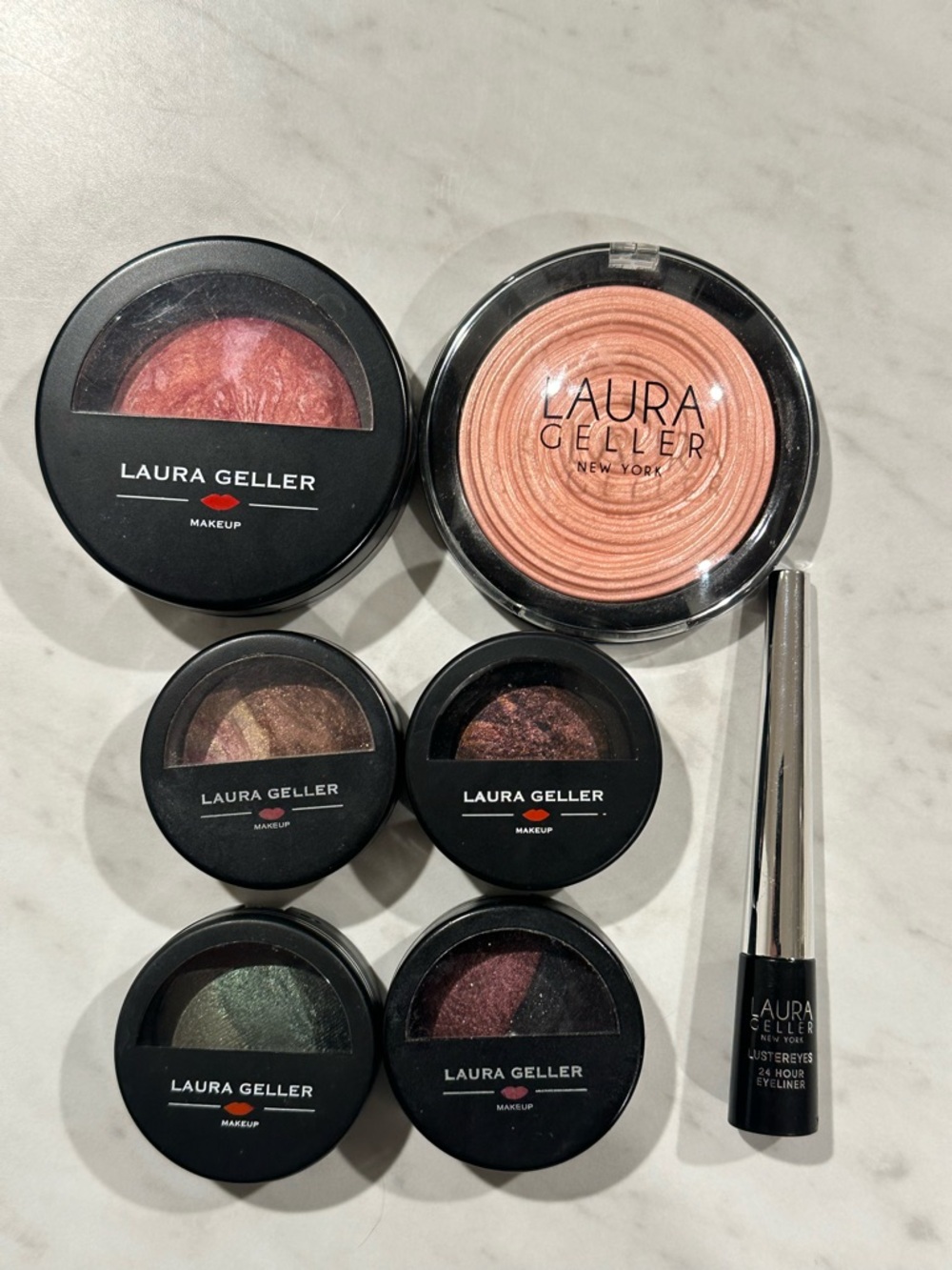 Laura Geller 7 piece set - blush, illuminator , 4 baked eyeshadow & eyeliner